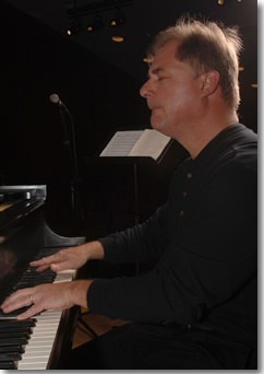 Professor Lawrence Price plays a piano