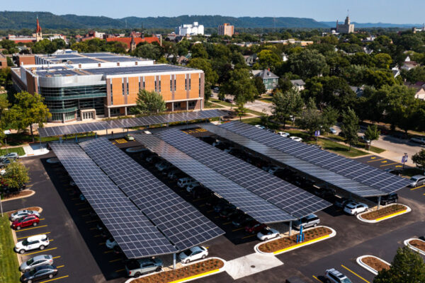 An aerial view of the Integrated Wellness Center parking lot with solar panel installations.