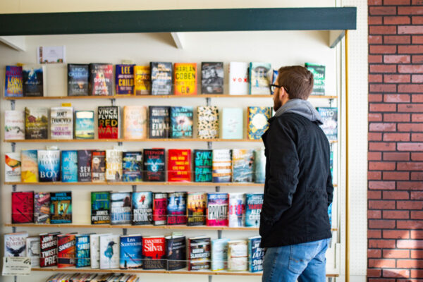 A male student walks into a local bookstore in Winona, MN.