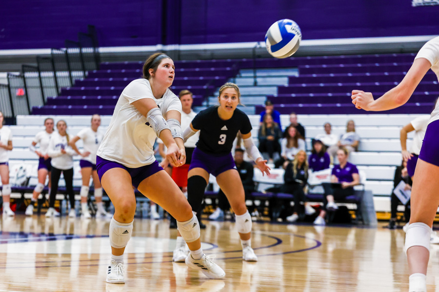 A Warriors volleyball player pass the ball to a teammate during a game.