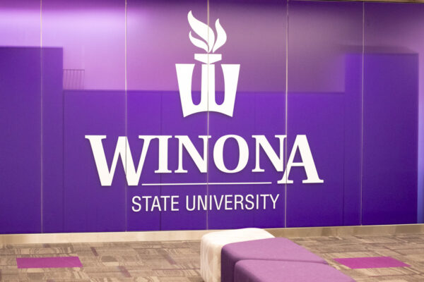 A purple wall with the WSU logo in a campus office.