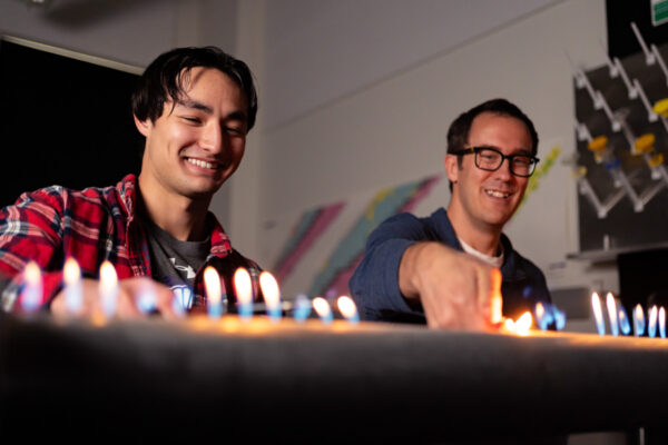 Two students use a flame table in a lab on the WSU campus.