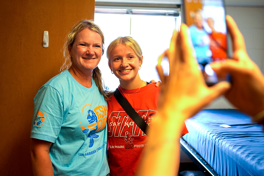 WSU student visiting with a family member in a residence hall