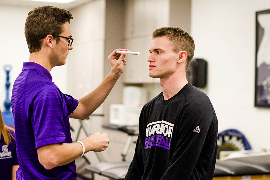 WSU Athletic Trainer student working with a Warrior athlete
