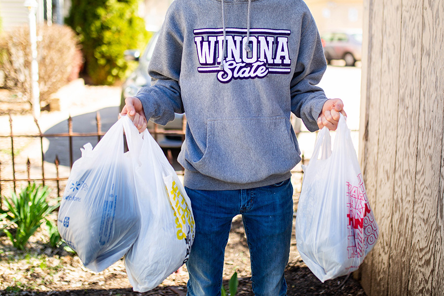 WSU student holding trash bags