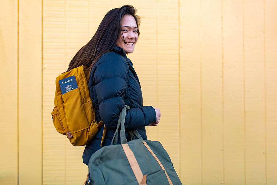 WSU student with passport and luggage