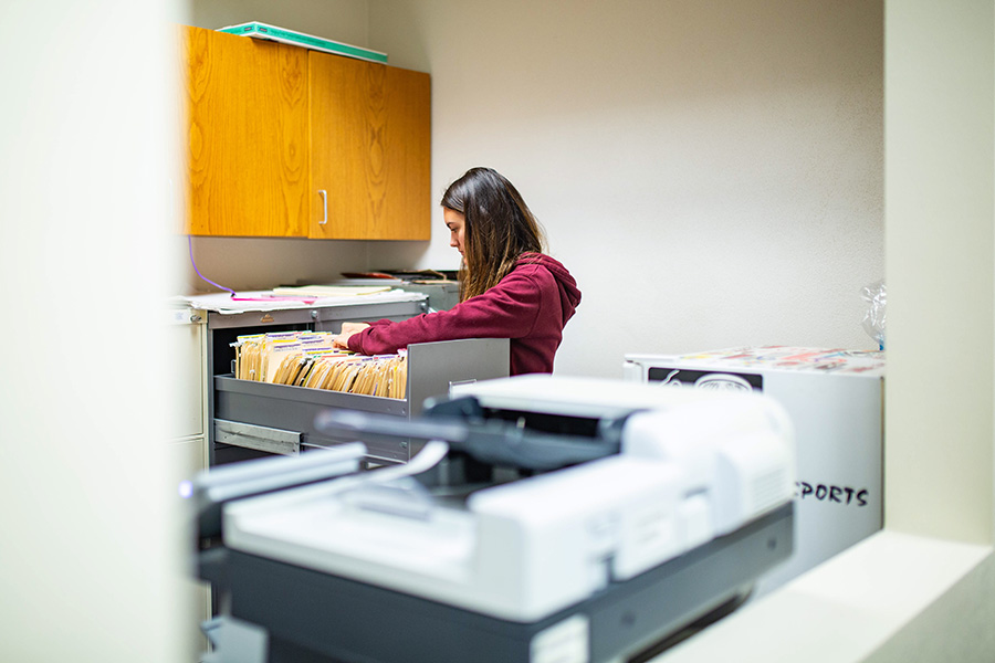 WSU student worker going through filing cabinet