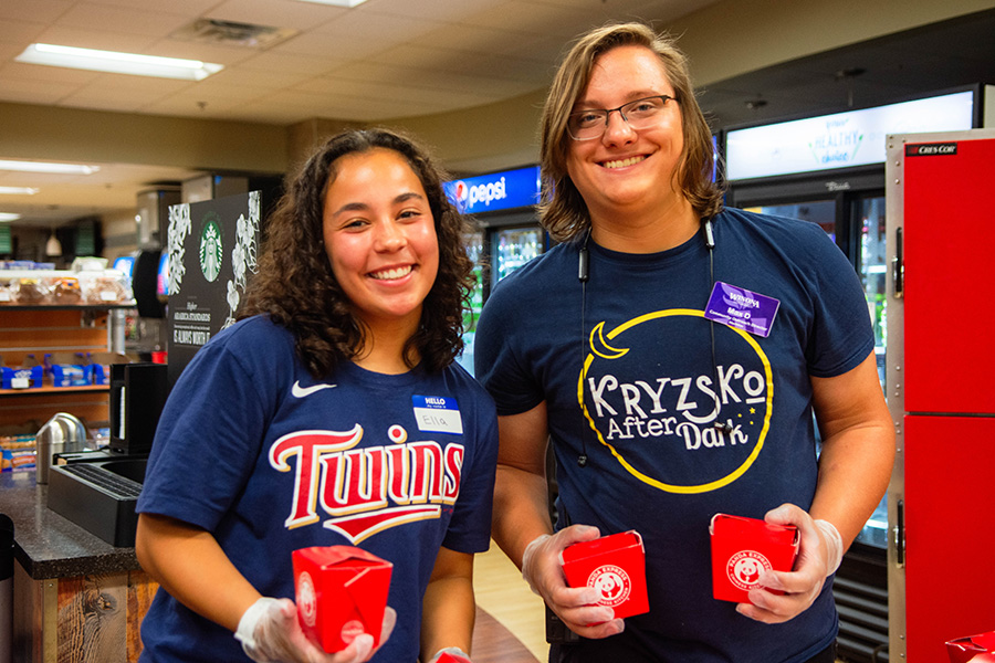 WSU students attending Kryzsko After Dark and holding Panda food containers
