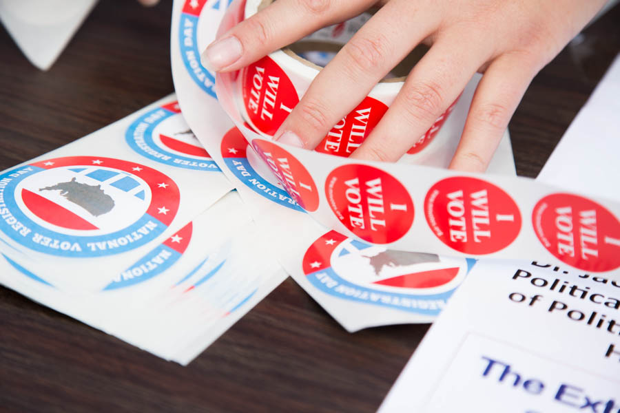 Political science brochure and vote stickers on a table