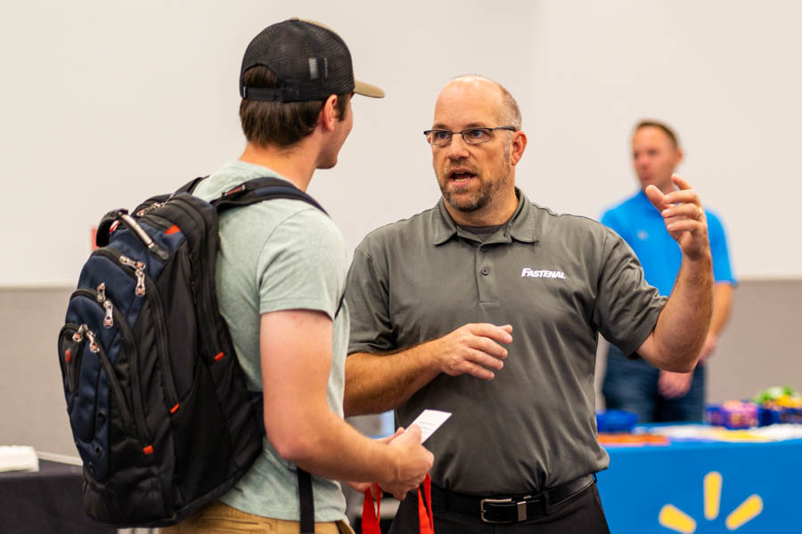 Student speaking with an employer at job and internship fair