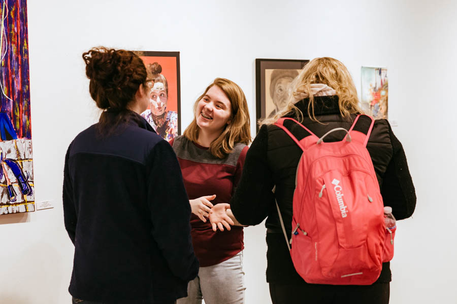 WSU students talking in an art gallery