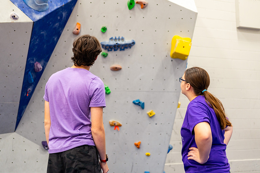 WSU students looking at the climbing wall.