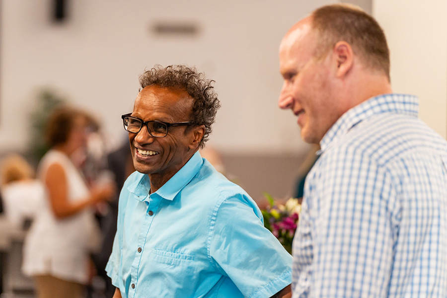 Two WSU faculty members smiling at an employee event.