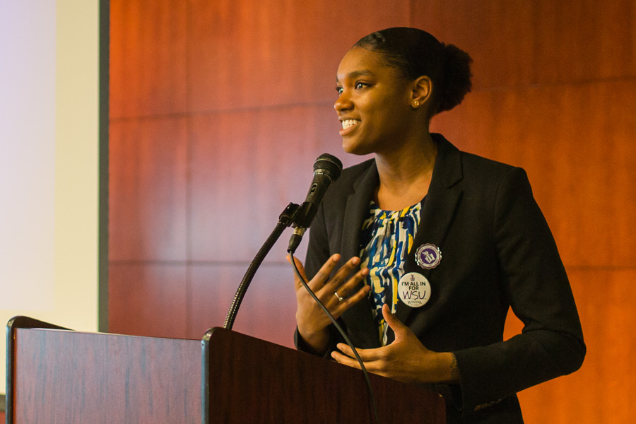 WSU student speaking at a podium.
