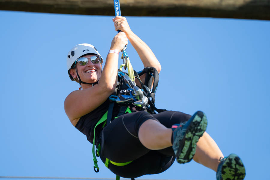 WSU high ropes course participant using the zipline.