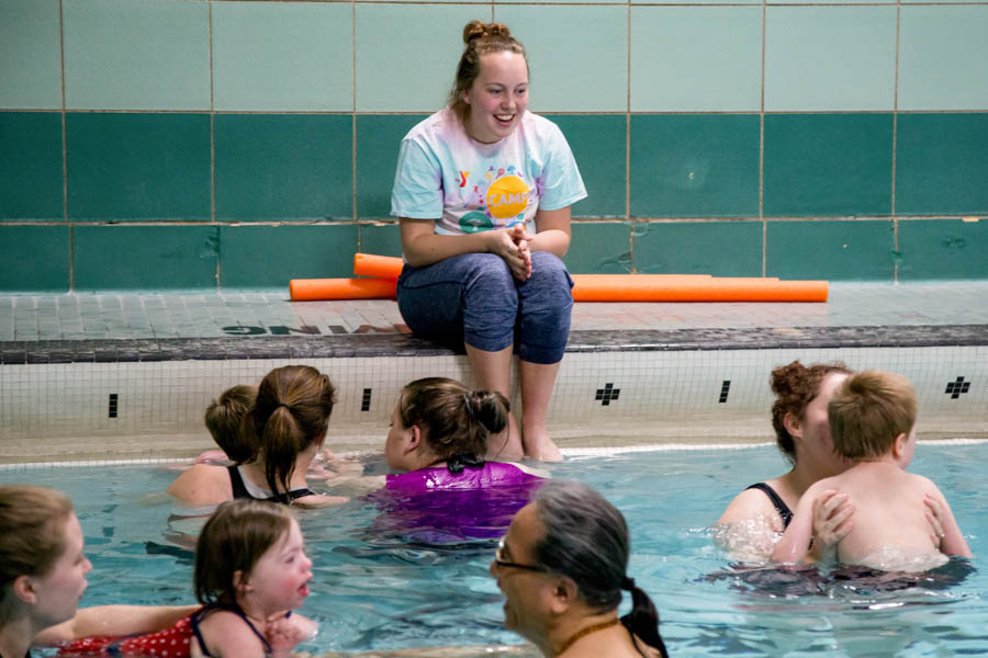 WSU student lifeguard watching people swim in Memorial Pool.