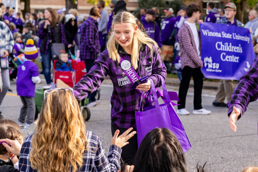WSU students handing out merch at the Homecoming Parade.
