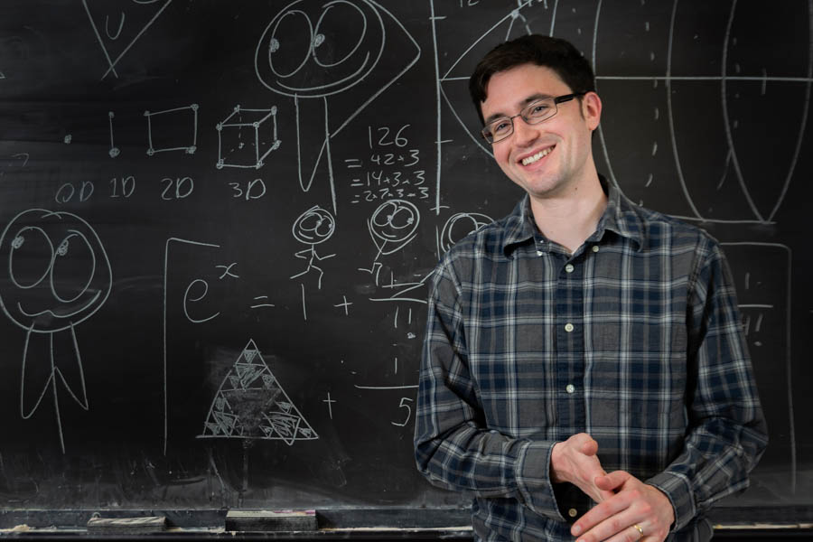 Ben Orlin standing in front of a chalkboard.