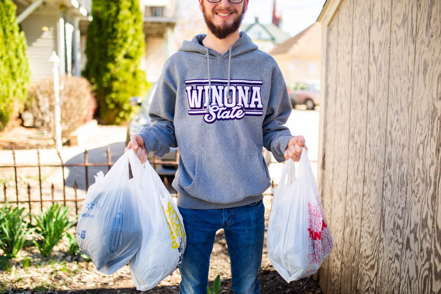 WSU male student holding garbage bags