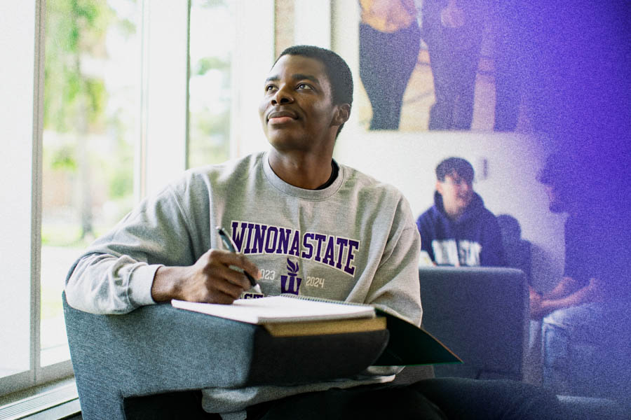 Winona State student sitting and doing homework.