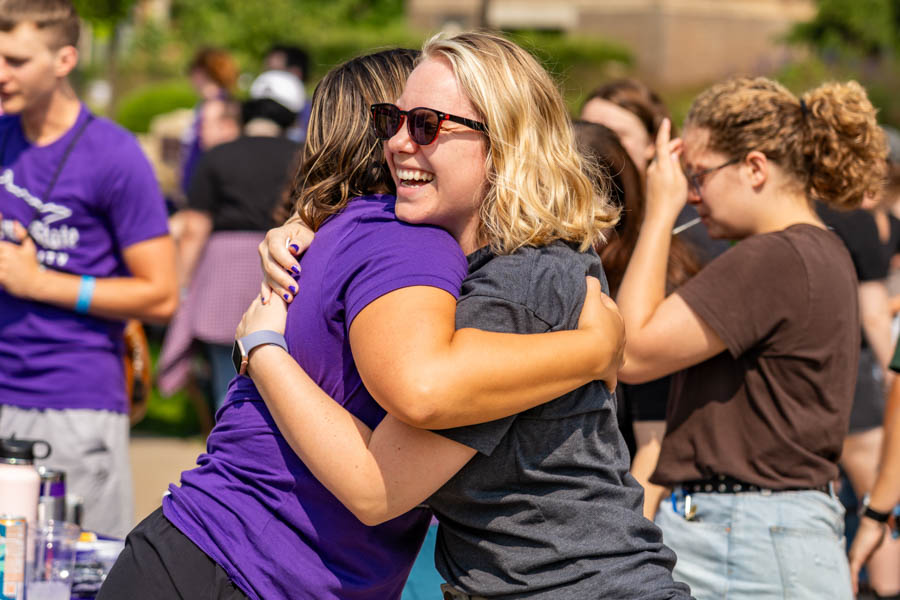 WSU students hugging and smiling at an event