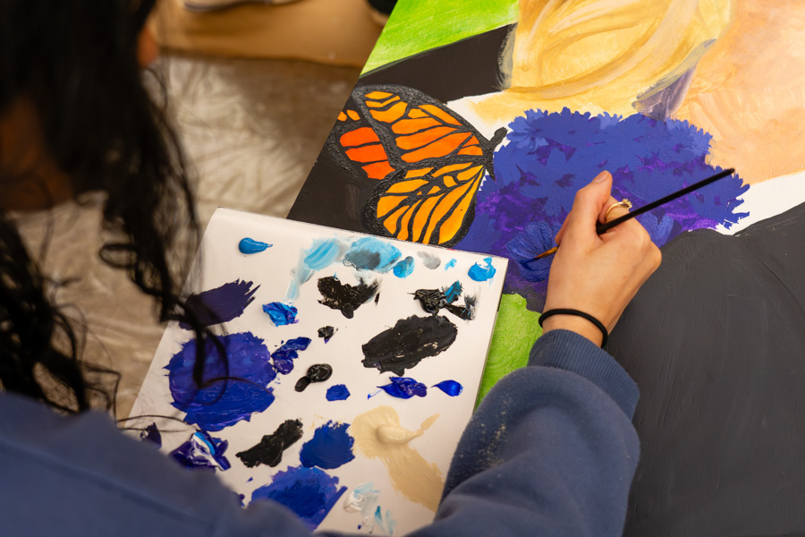 WSU student painting on a canvas