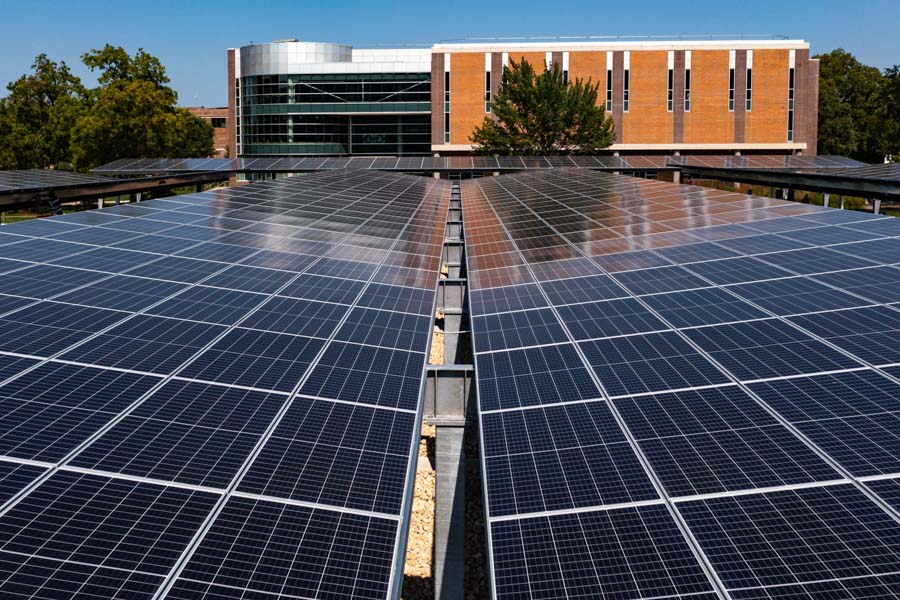 Solar panels construction over outdoor parking lot.