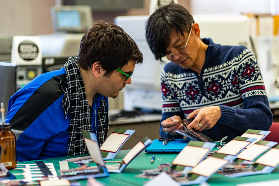 WSU Art student works with a faculty member.