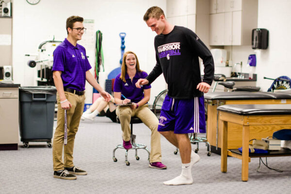 Athletic Training students working with a Warrior athlete.