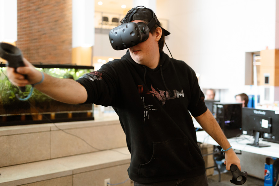 WSU male student using virtual reality (VR) equipment.