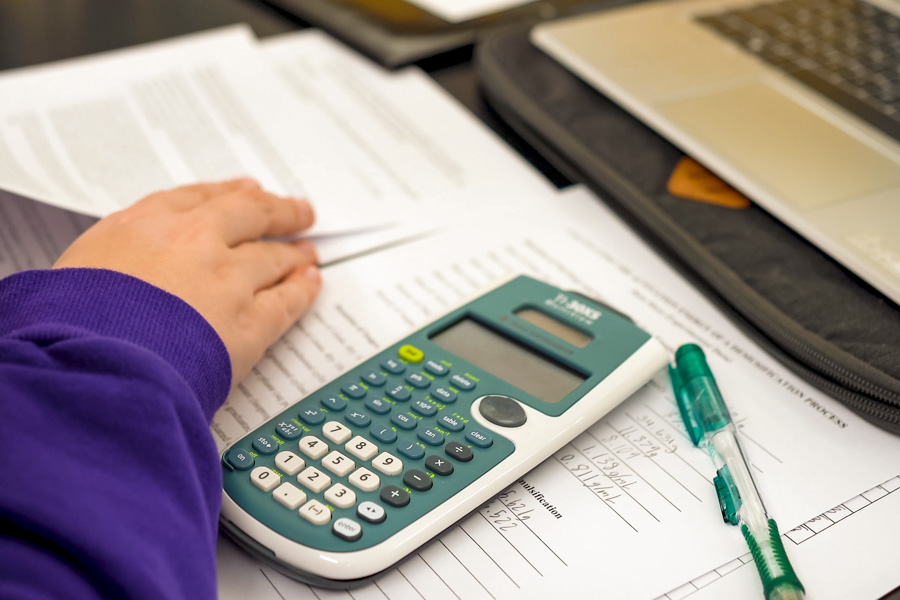 WSU student using a calculator for homework assignment.