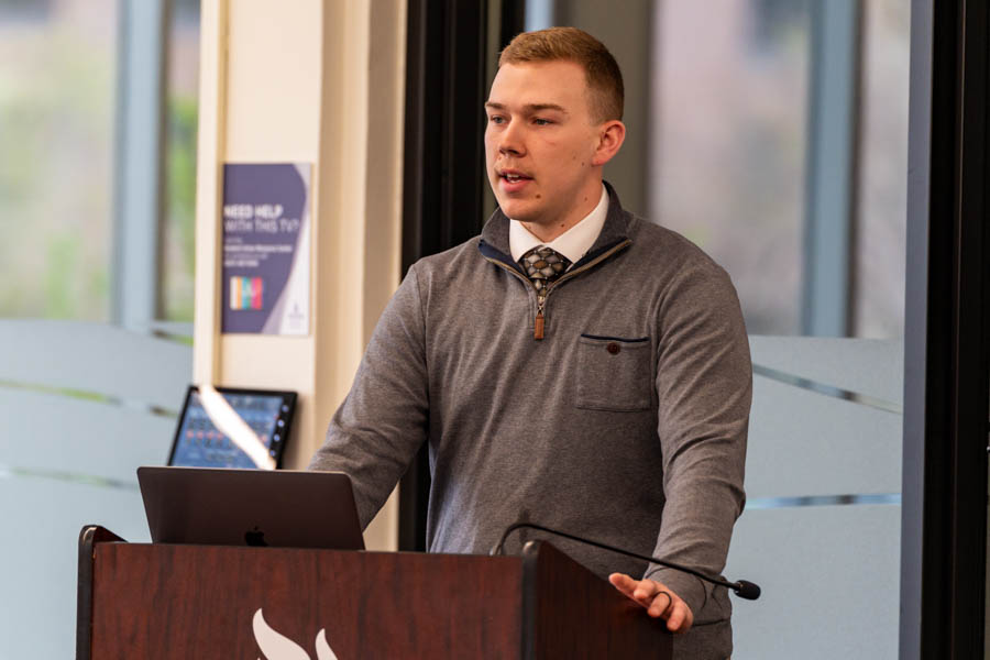 WSU student speaking at a podium before an audience.