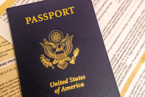A United States passport laid on various application papers.