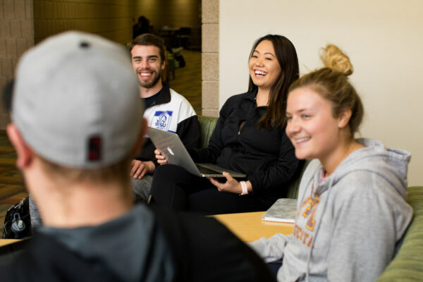 A group of students work together in a study lounge.