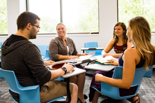 Four students have a discussion in class at the WSU Education Village.