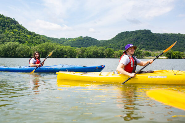 Two students kayak on Lake Winona.