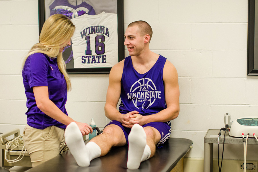 A WSU student examines an athlete in the Athletic Training facility.