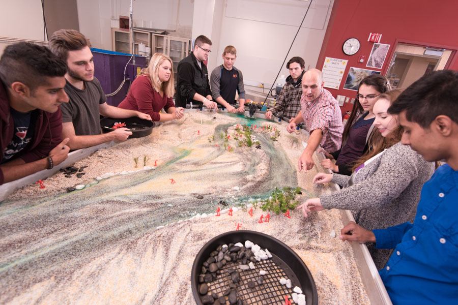 A professors explains scientific concepts to a class of students