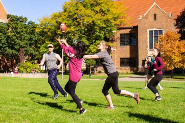 A group of student play football on the WSU campus.