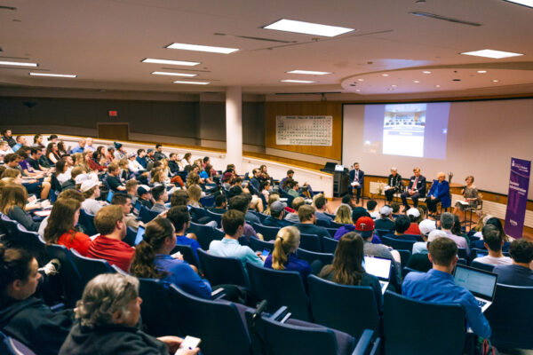 A guest speaker presents to a group of students in a lecture hall on WSU campus.
