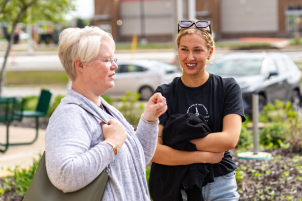 A student talks with a faculty member on the WSU campus.