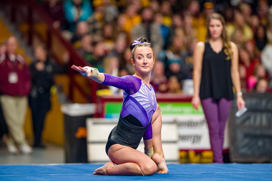 Student athlete holding a pose during a gymnastics meet.