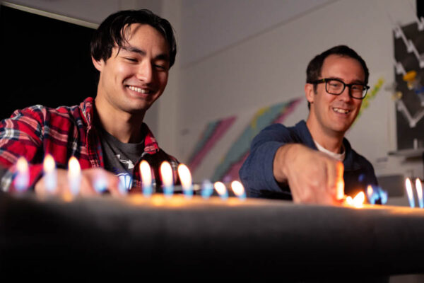 Professor Adam Beardsley with a student at a fire table