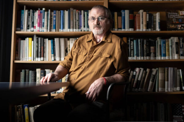 Professor Talan Memmott sitting in a chair