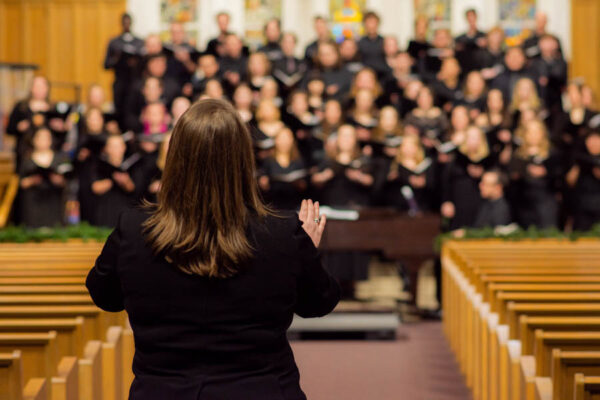 WSU Professor Colleen Chester conducting during a choir performance