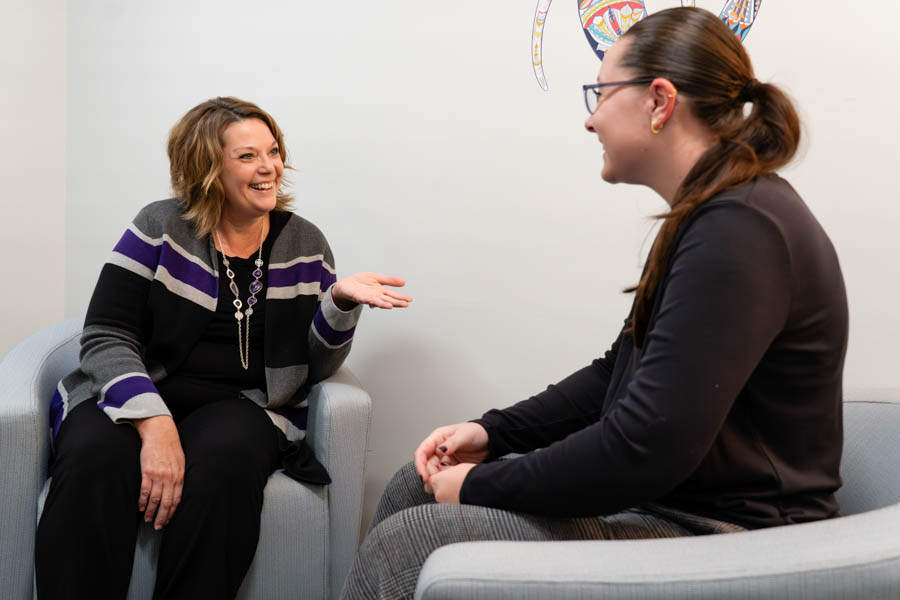 Counselor speaking with a patient in an office setting.