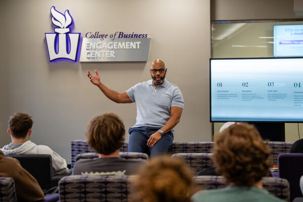 A guest speaker addresses students in the College of Business Engagement Center