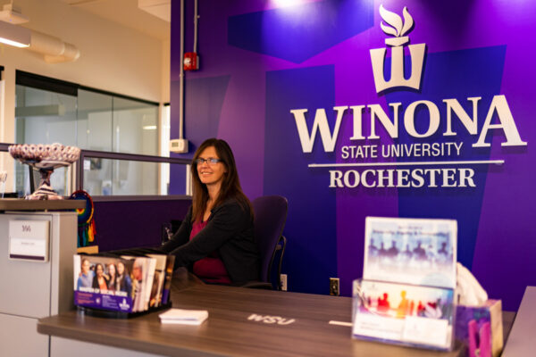 A staff person greets visitors on the WSU-Rochester campus.