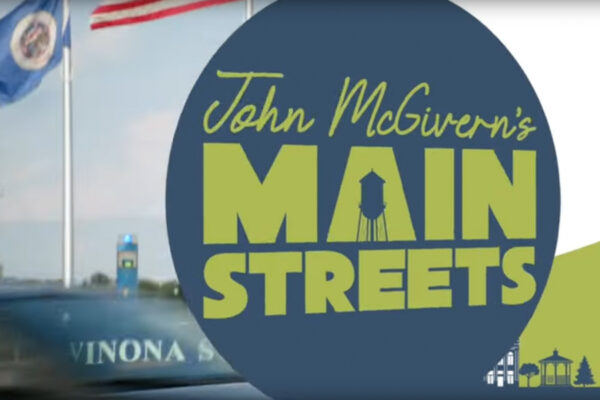 The logo for John McGivern's Main Streets show layered over a view of WSU signage.