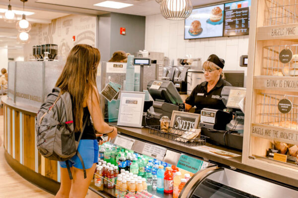 A student orders food at the coffeeshop in the WSU Library.